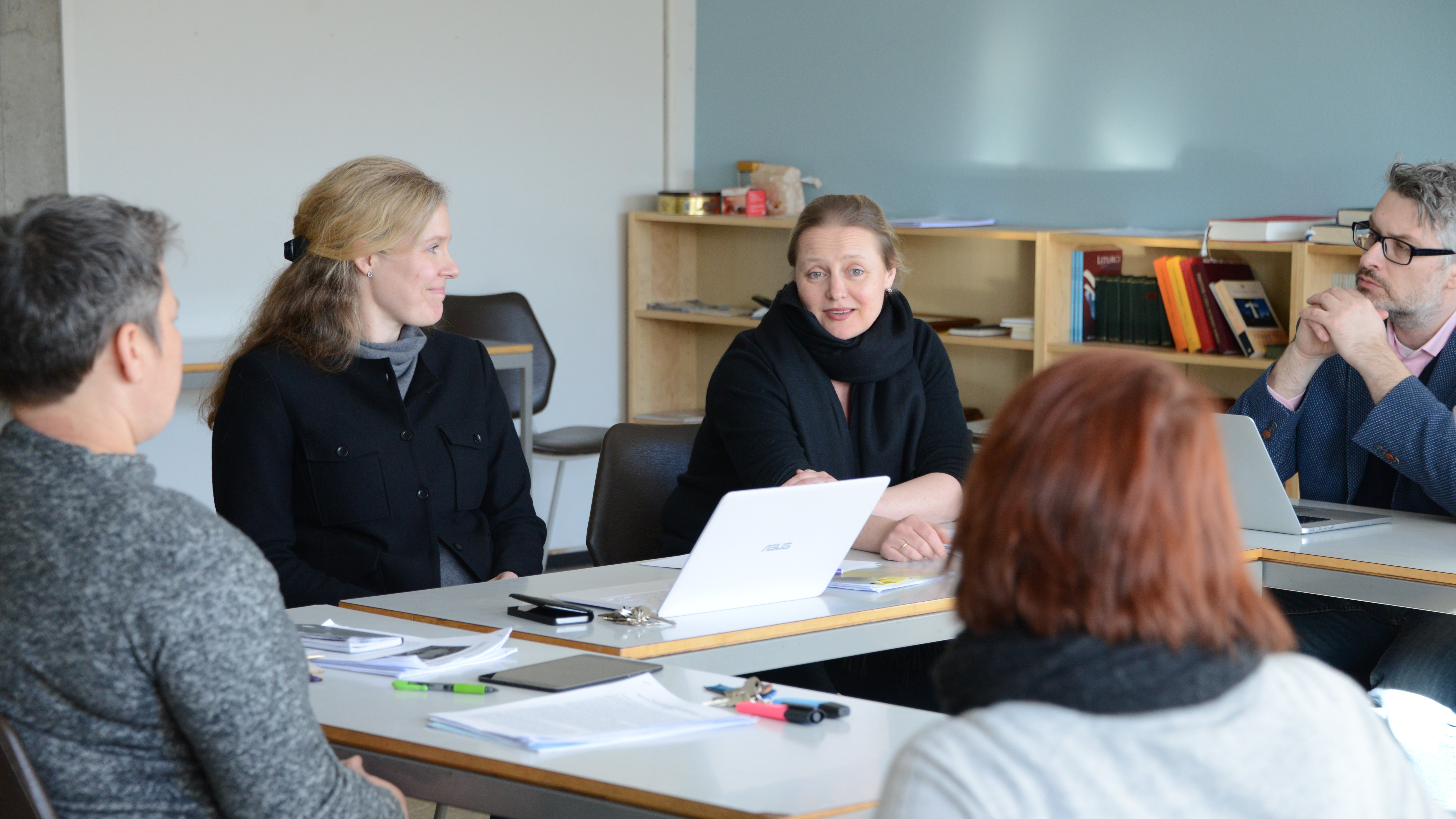 Photo of researchers talking together.