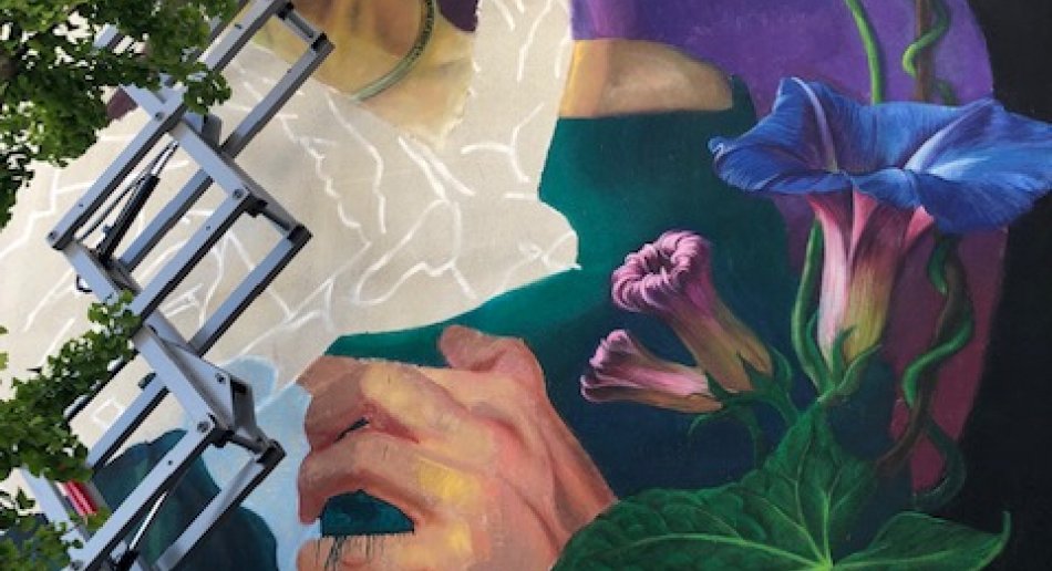 A mural of morning glory flowers, a hand, and a flying bird.