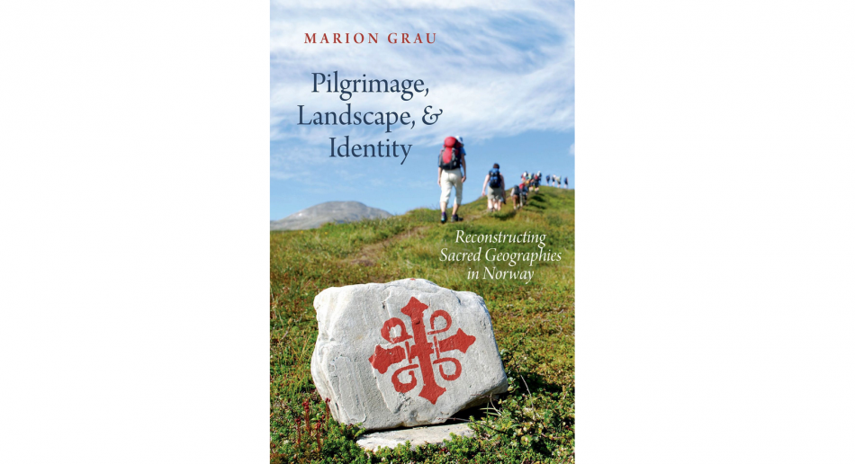 A book cover with hikers against a blue sky and a cross on a stone in the front, with the text "Marion Grau - Pilgrimage, Landscape, & Identity"