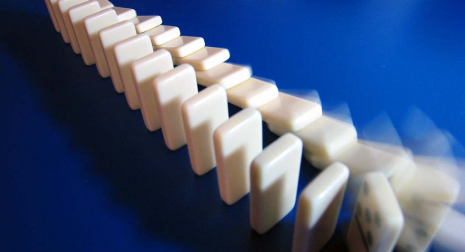 A row of falling dominos on a blue background.